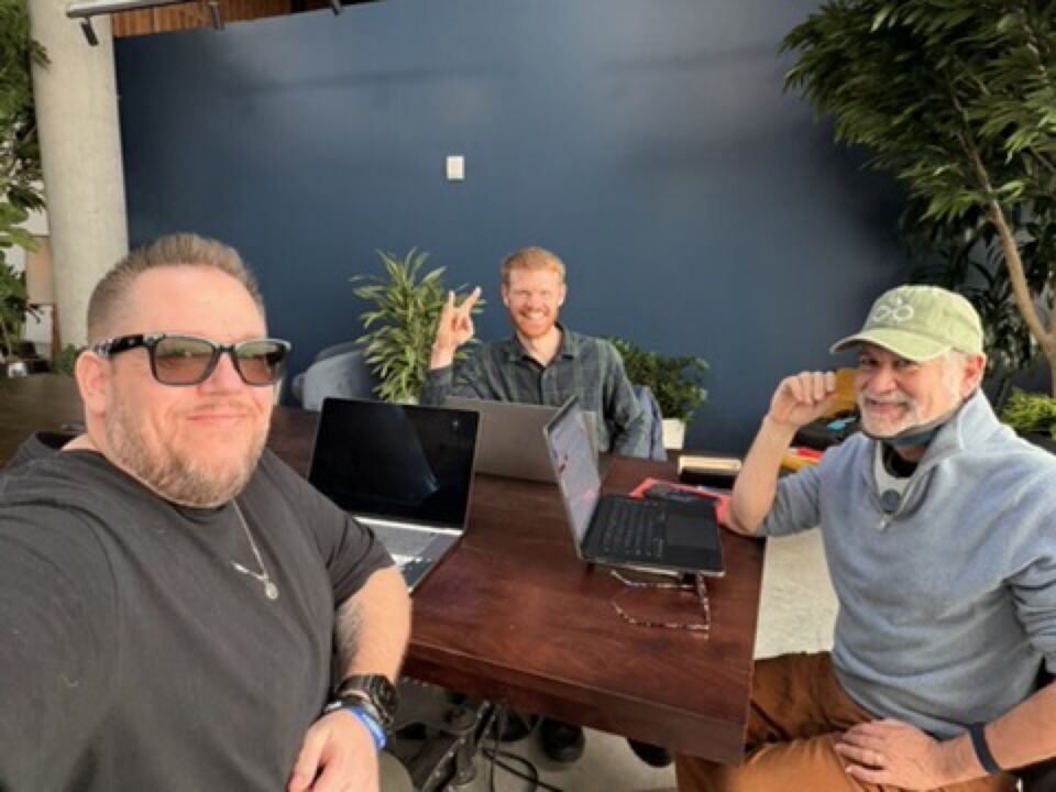 JJ and two guests in a meeting room
