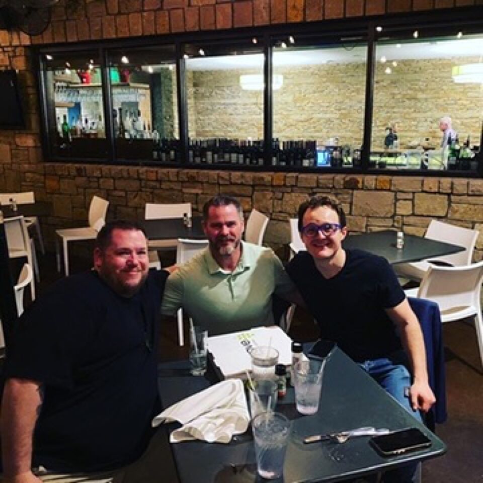 JJ and two guests at a restaurant table
