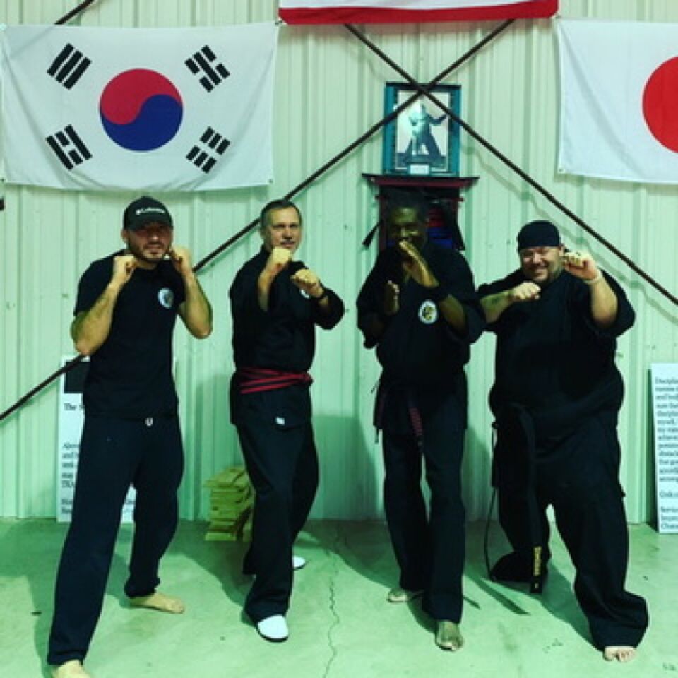 JJ with martial arts students in a dojo