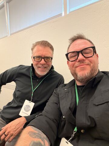 JJ and a guest wearing conference badges