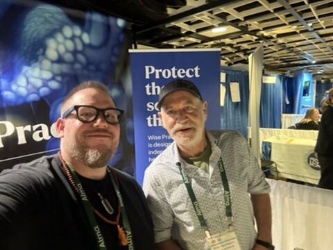 JJ and a guest at an expo booth