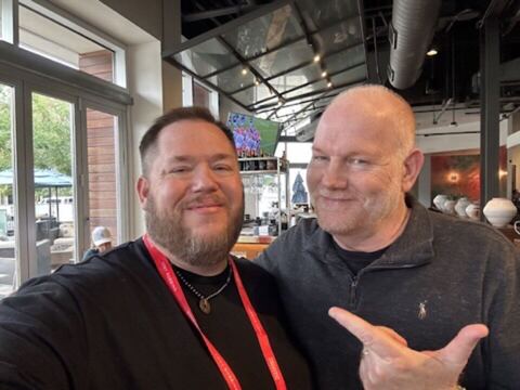 JJ and a guest at a conference venue
