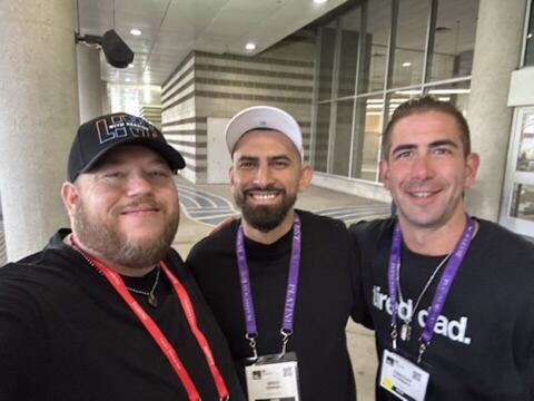 JJ and two guests at a conference