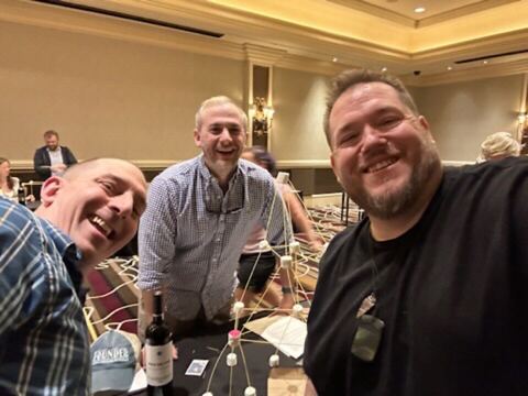 JJ and guests at a dinner table
