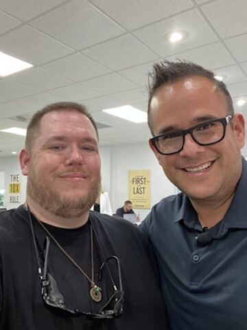 JJ and a guest in an office