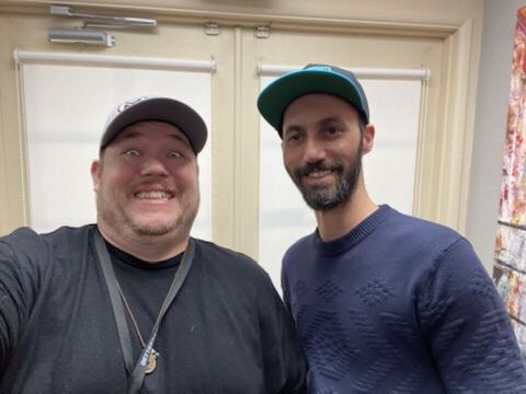 JJ and a guest in a hallway